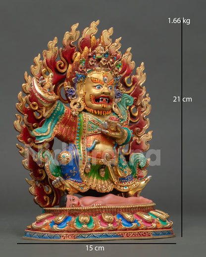 Side view of wrathful Mahakala statue holding flaying knife and skull cup with hand painted acrylic copper detailing