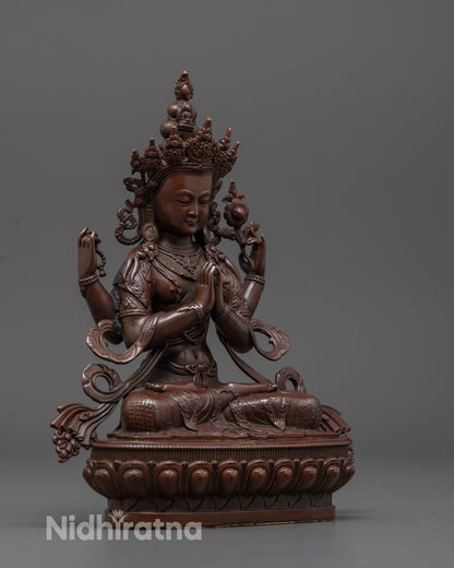 Side angle of electroplated Chenrezig statue holding wish-fulfilling gem on lotus base