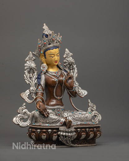 side angle of Green Tara in varada mudra with detailed robe, jewelry, and lotus seat