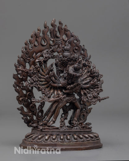 side angle of Kalachakra statue showing flowing robes and lotus seat with deities