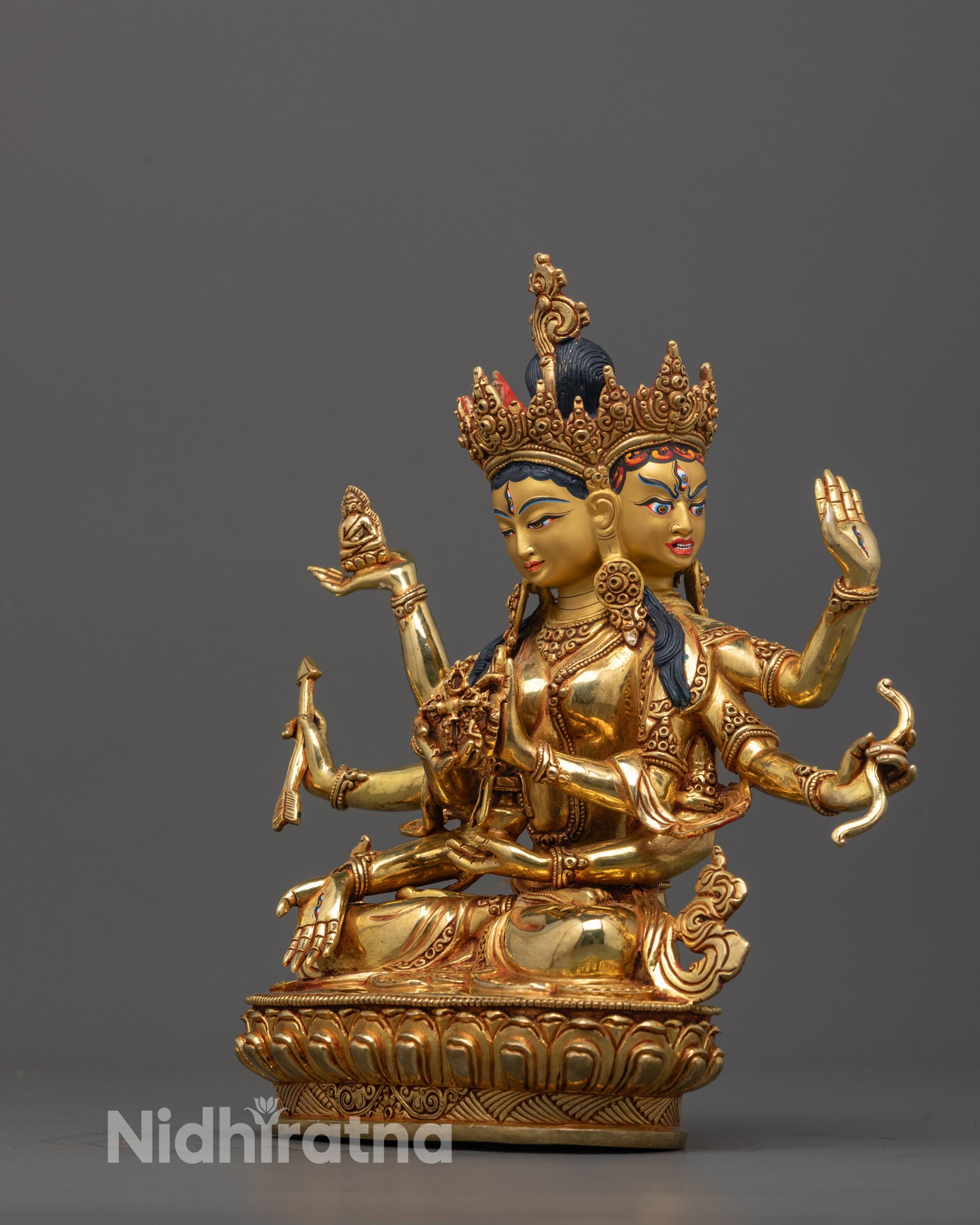 side angle of gold-gilded Namgyalma sculpture showing robe and sacred objects