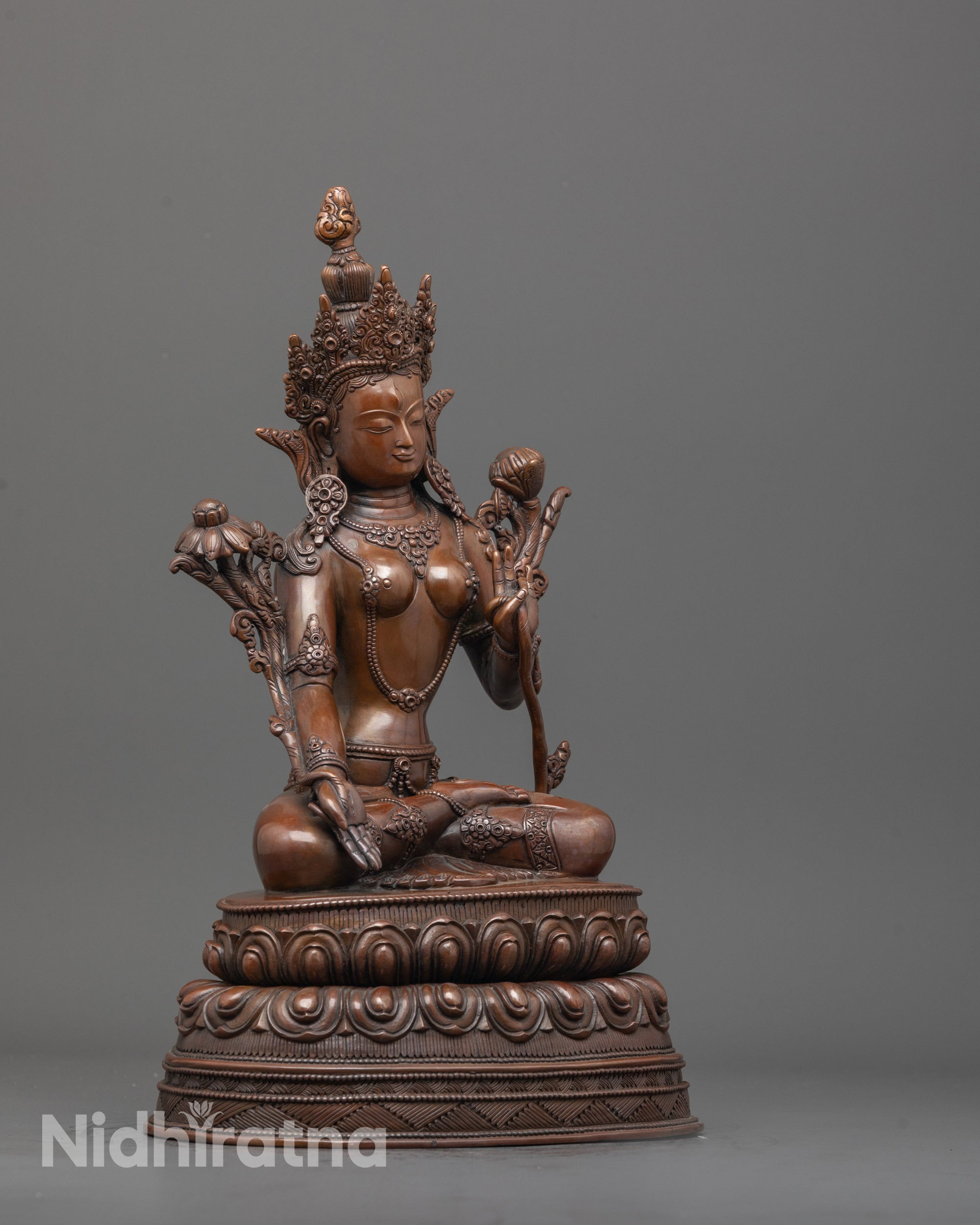 side angle of handcrafted oxidized white tara statue with lotus base and seven eyes