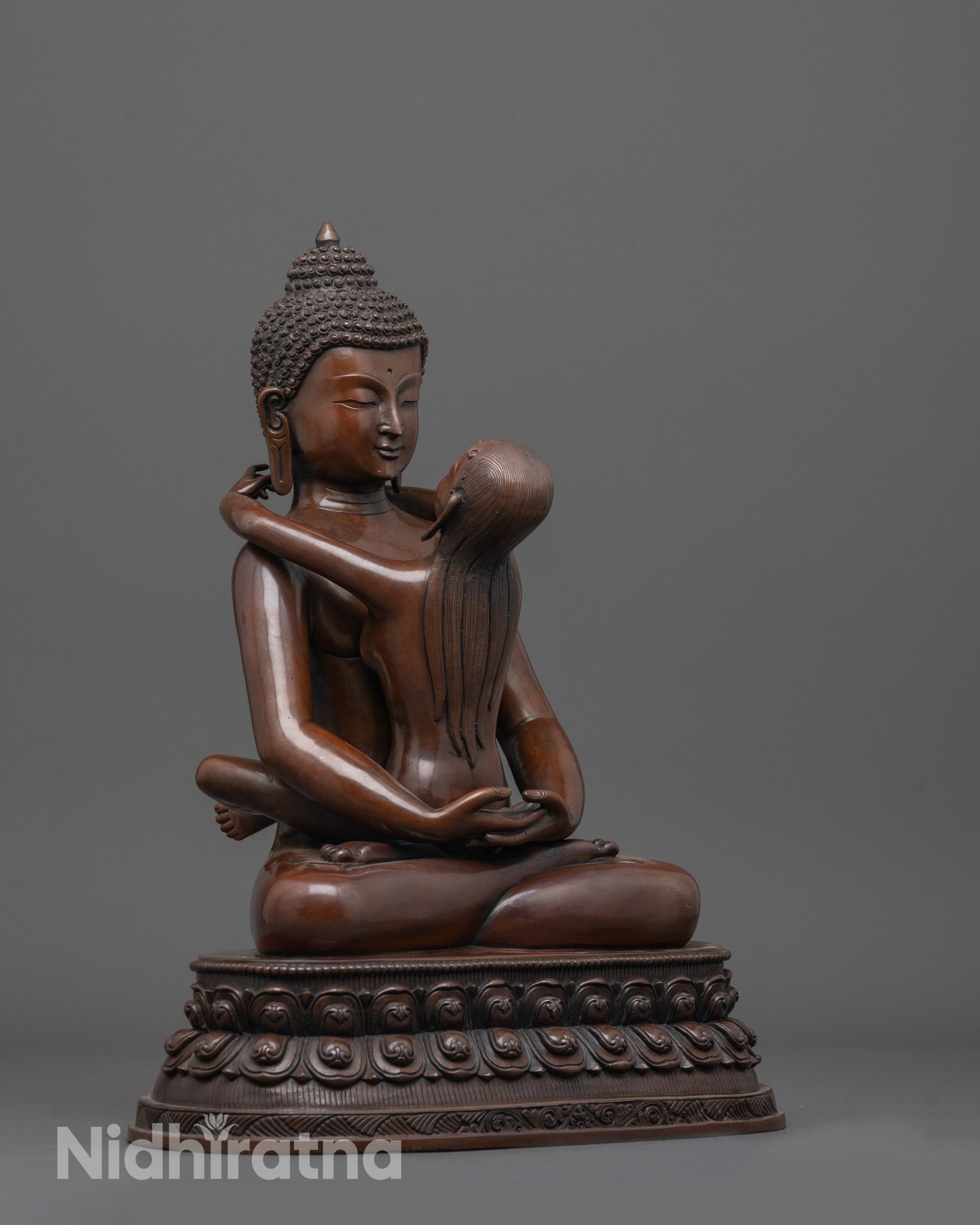 side angle of oxidized samantabhadra statue revealing detailed robe folds and spiritual posture