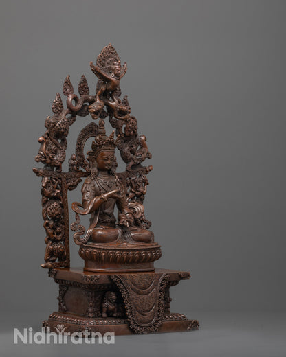 side angle of vajrasattva statue highlighting vajra bell and flowing patterned robe details