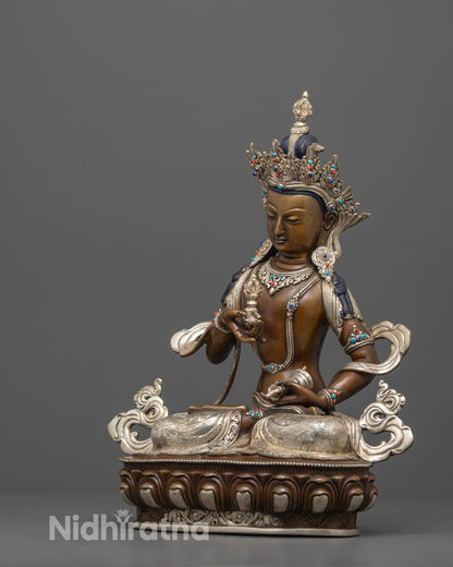 side angle of vajrasattva statue showing detailed robes and silver-plated ornaments
