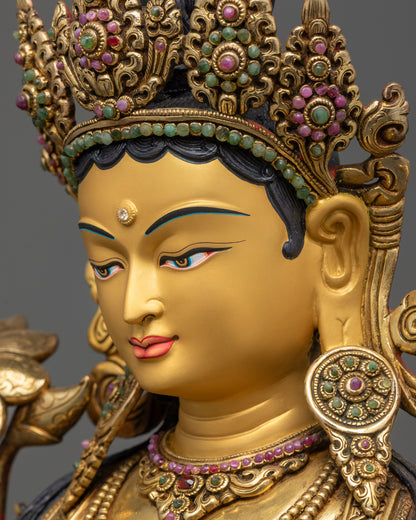 side close up face of Green Tara statue with five-jeweled crown and floral halo details