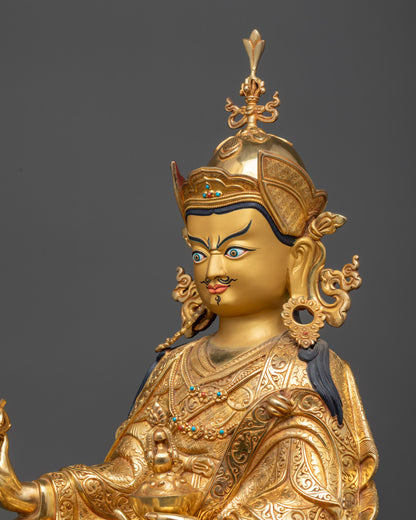 side close up face of Guru Rinpoche Padmasambhava statue with lotus hat and robe