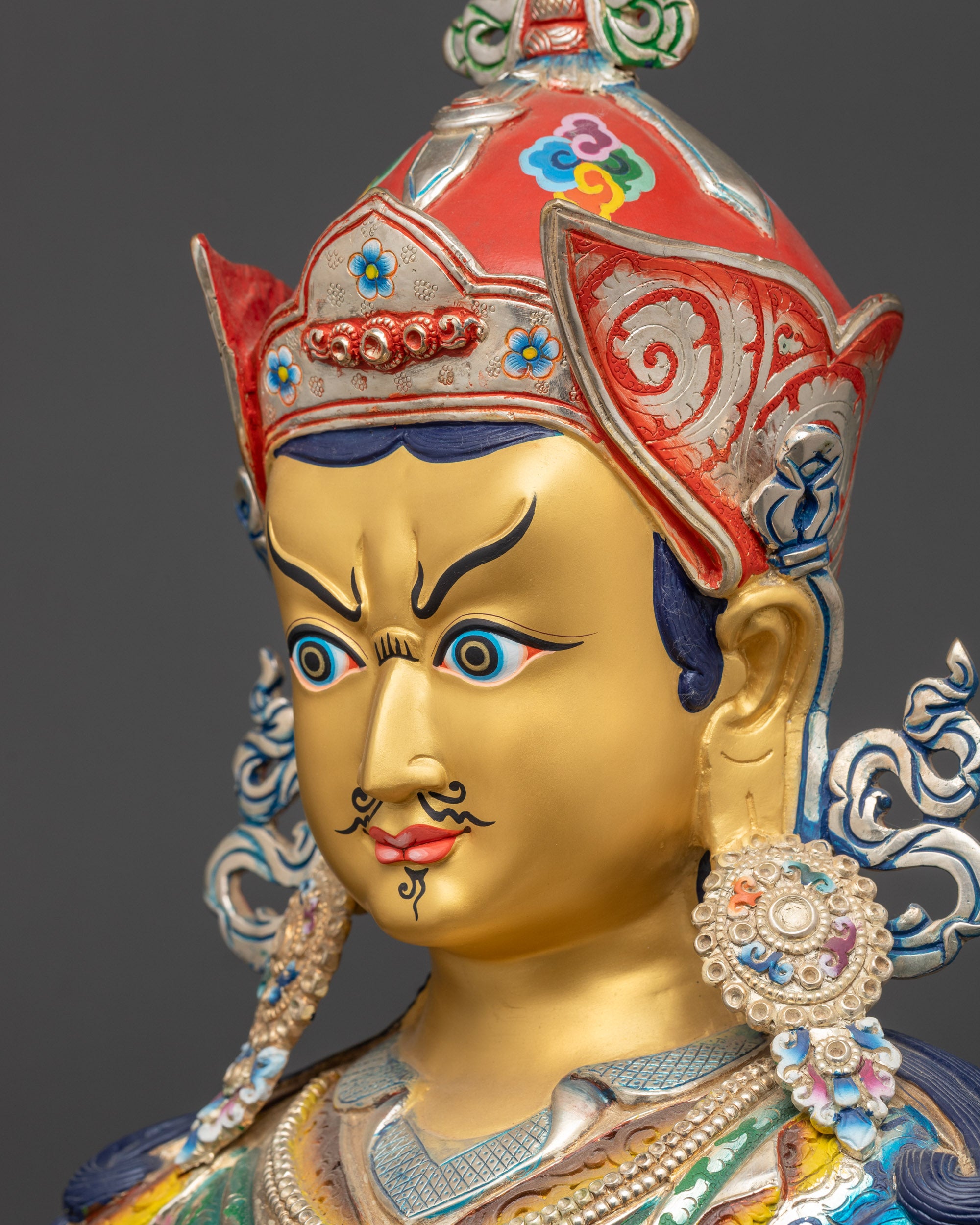 side close up face of Guru Rinpoche Sculpture with wrathful yet compassionate expression