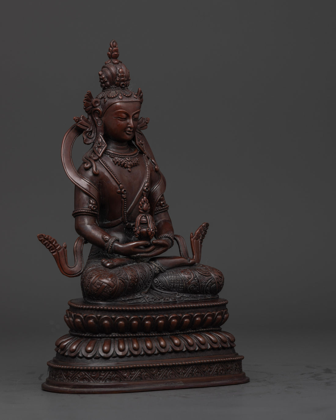 side view of oxidized amitayus buddha statue