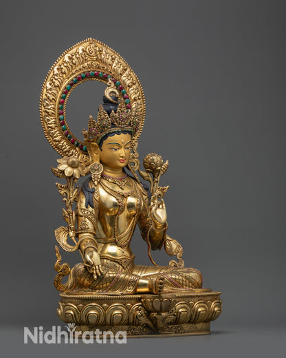 side view Green Tara statue seated on double-layered lotus base with gold-gilded face