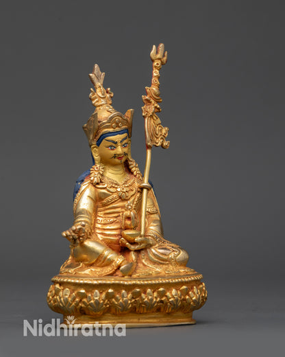 side view Padmasambhava statue highlighting khatvanga and flowing monastic robes

