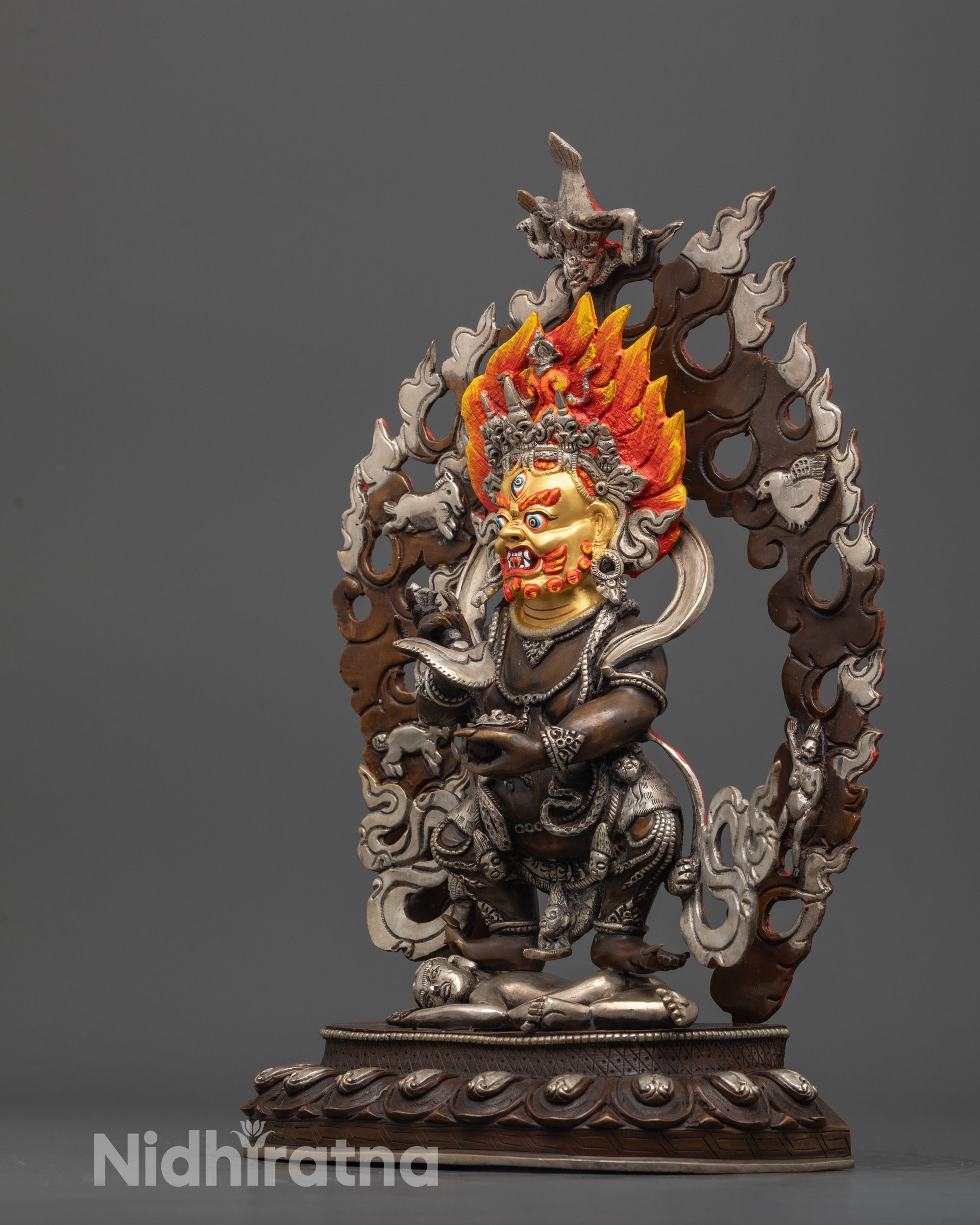 side view Sakya Mahakala statue with oxidized copper body and serpent garland accent