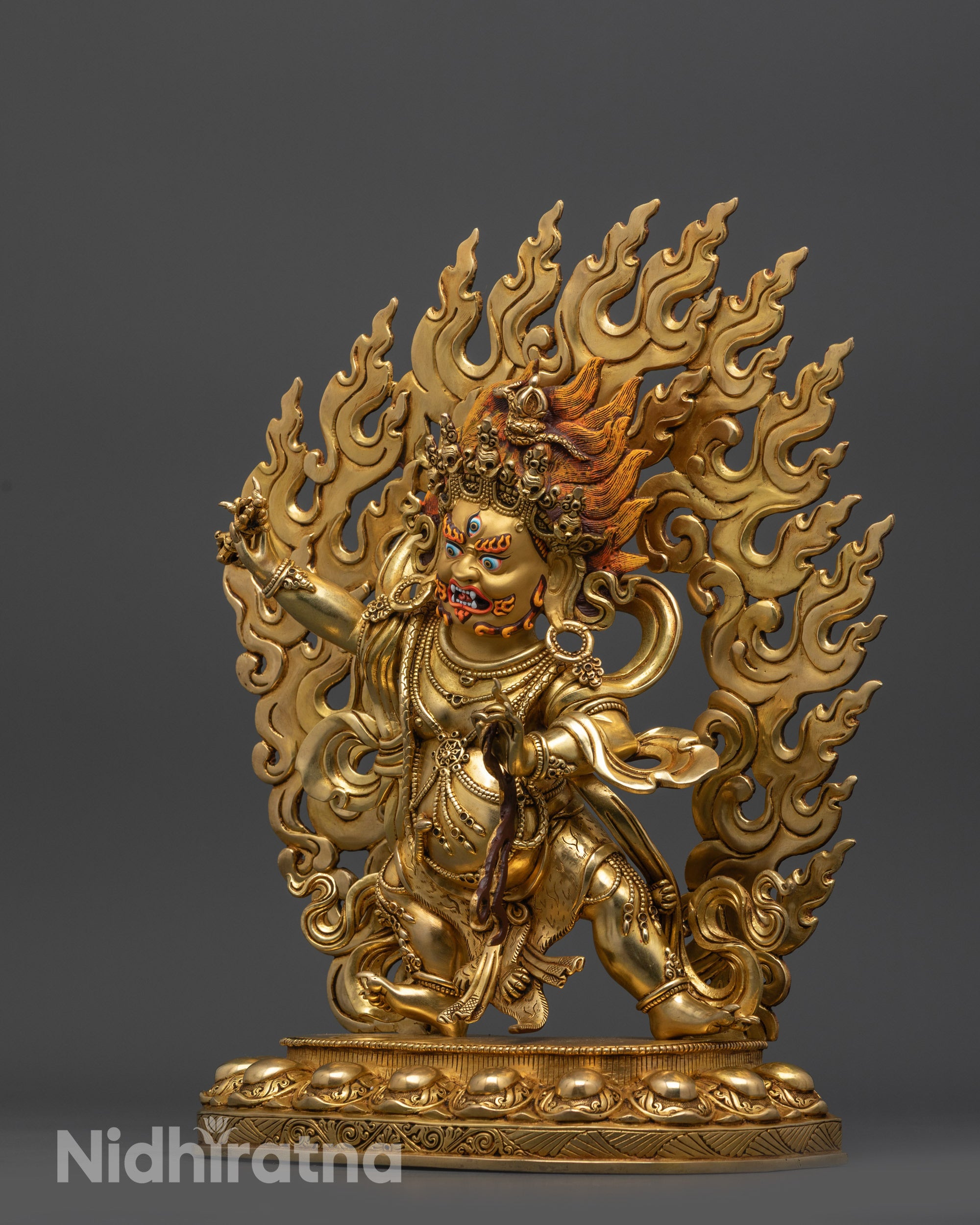 side view Vajrapani statue holding vajra and lasso atop lotus seat
