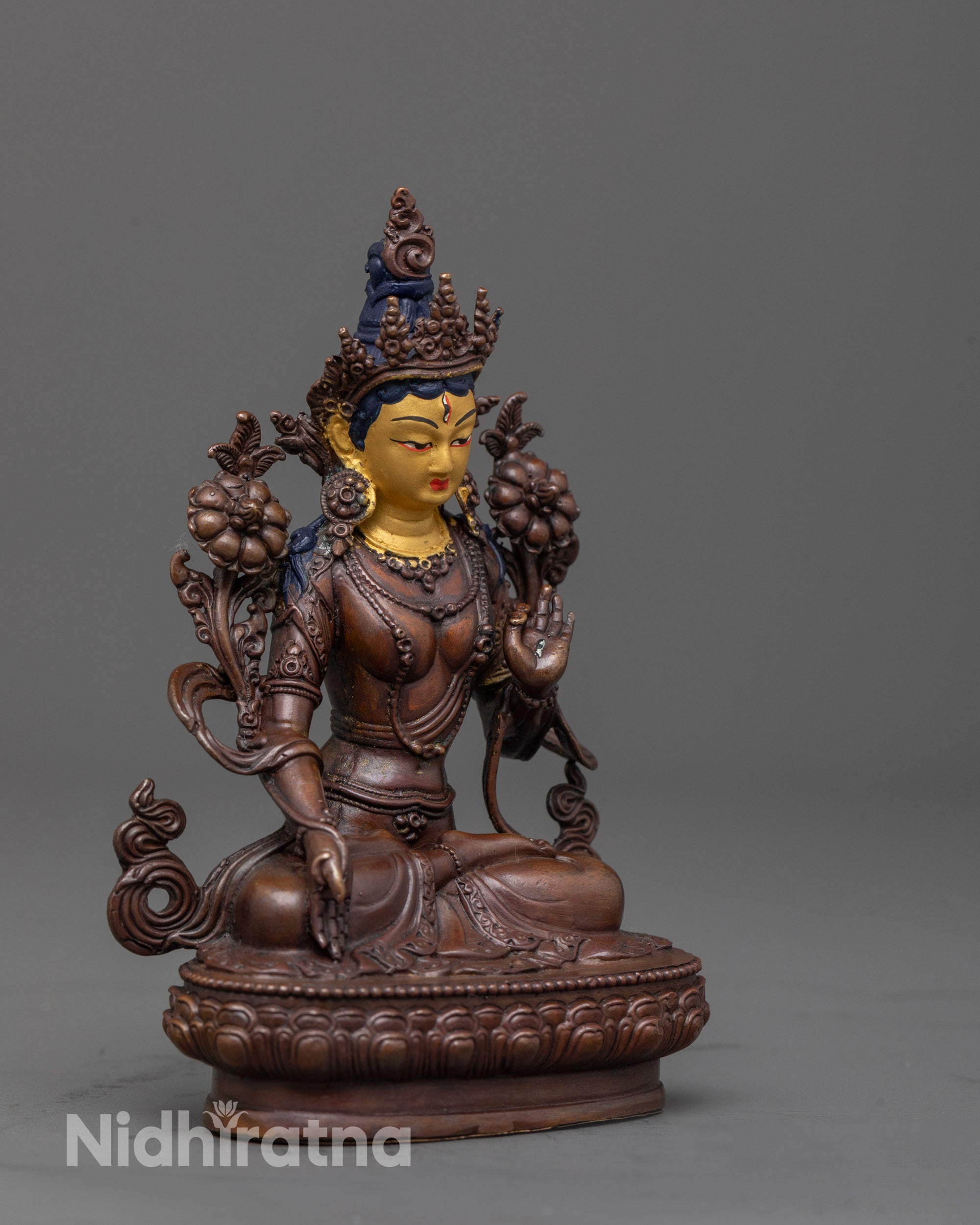 side view White Tara Statue showing oxidized copper body and seven seeing eyes details
