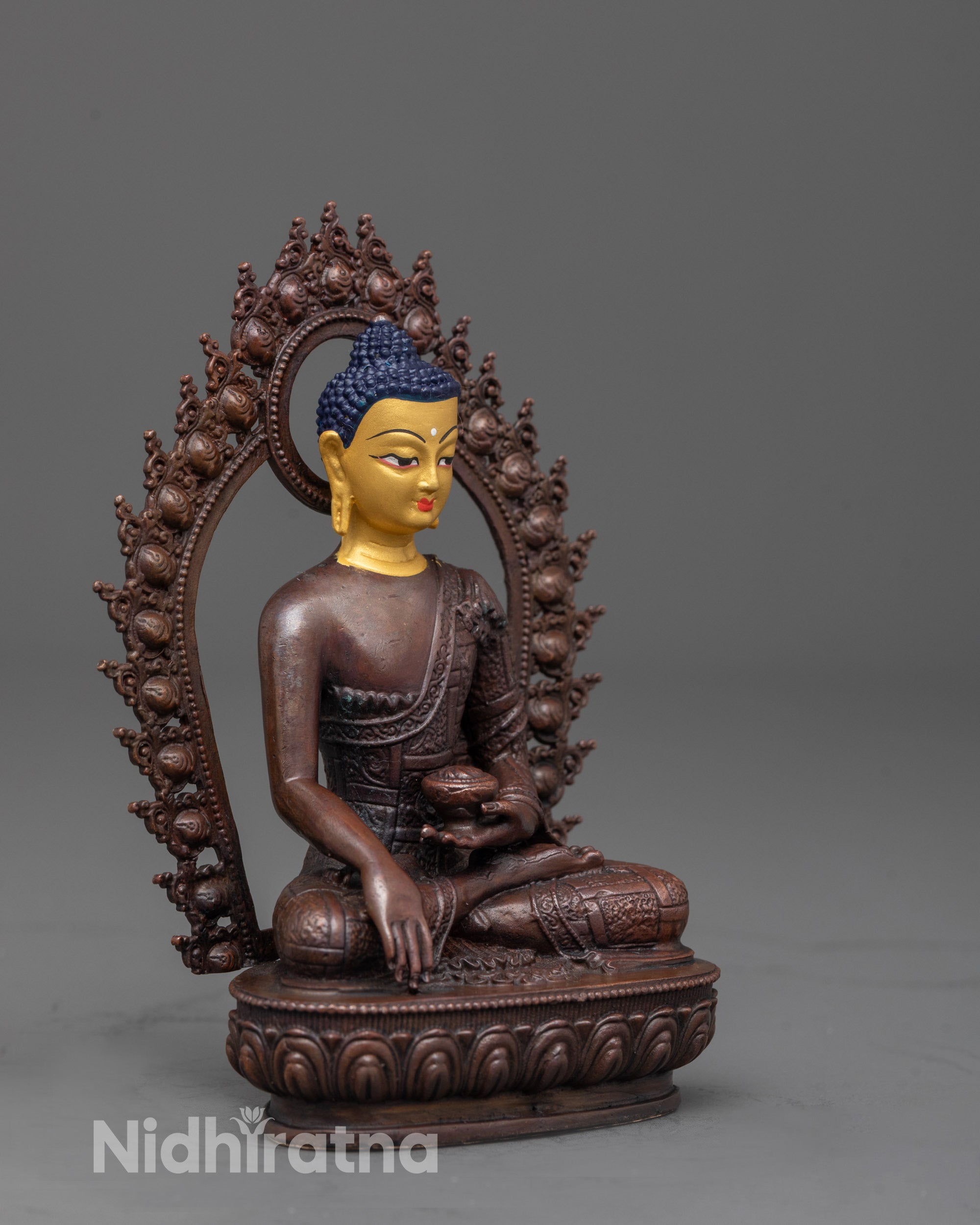 side view of Buddha Shakyamuni statue holding Patra bowl and seated on lotus with halo