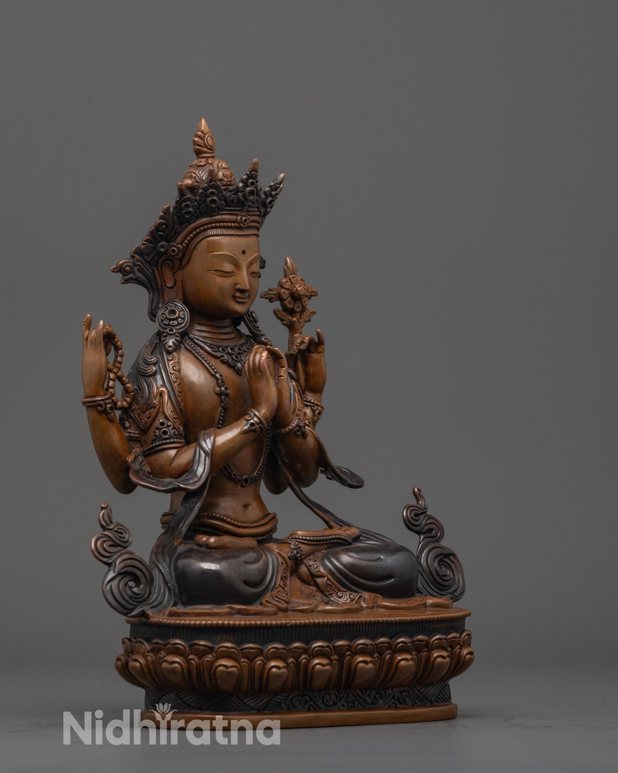 side view of Buddhist Lokeshvara statue showing carved lower garments and arm gestures