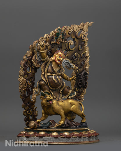 side view of dorje drolo statue showing tigress crushing demons and carved robe