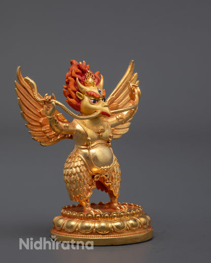 side view of garuda statue showing sculpted wings and feathered lower body