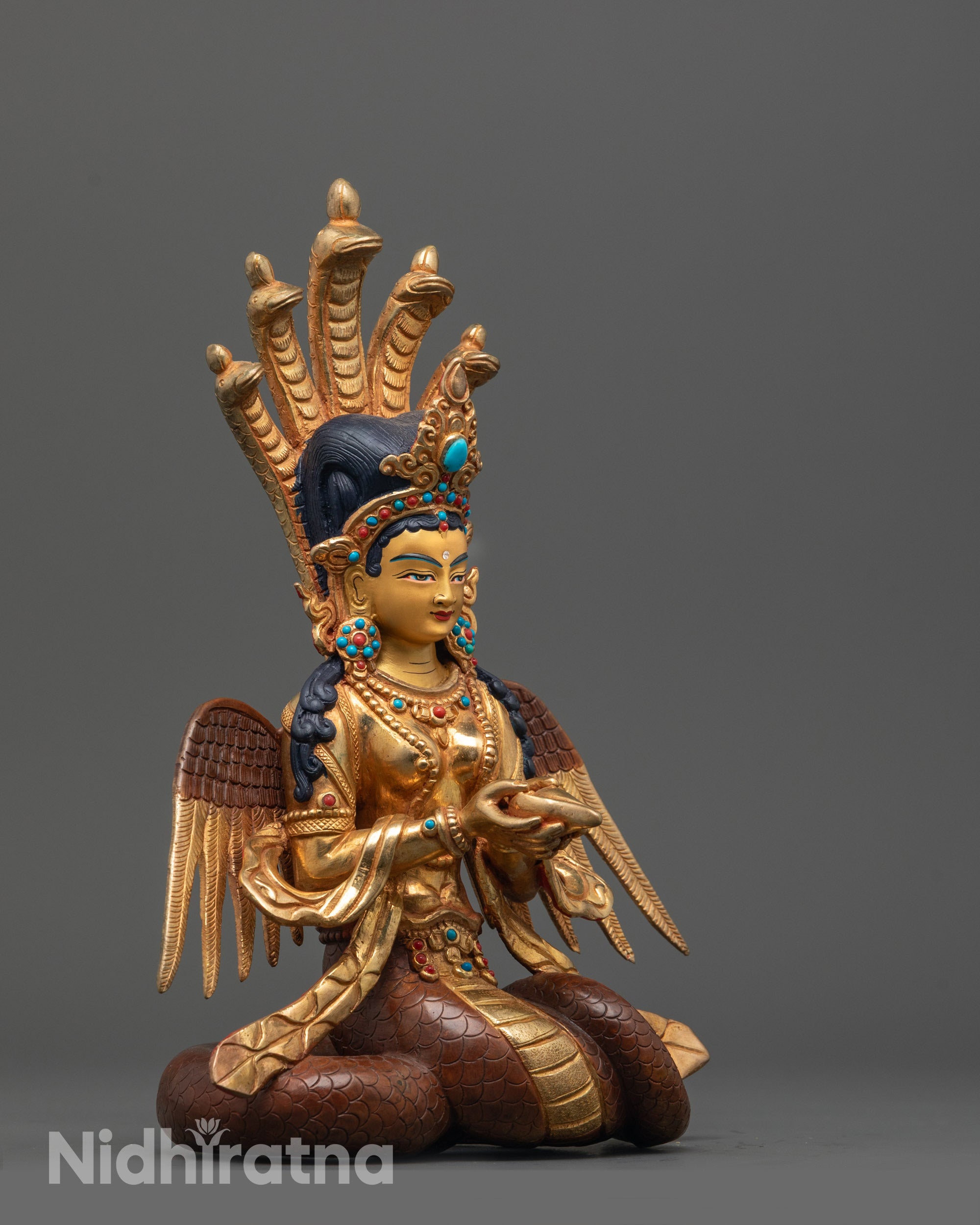 side view of gold fire-gilded body and copper base on Naga Kanya half-human serpent statue