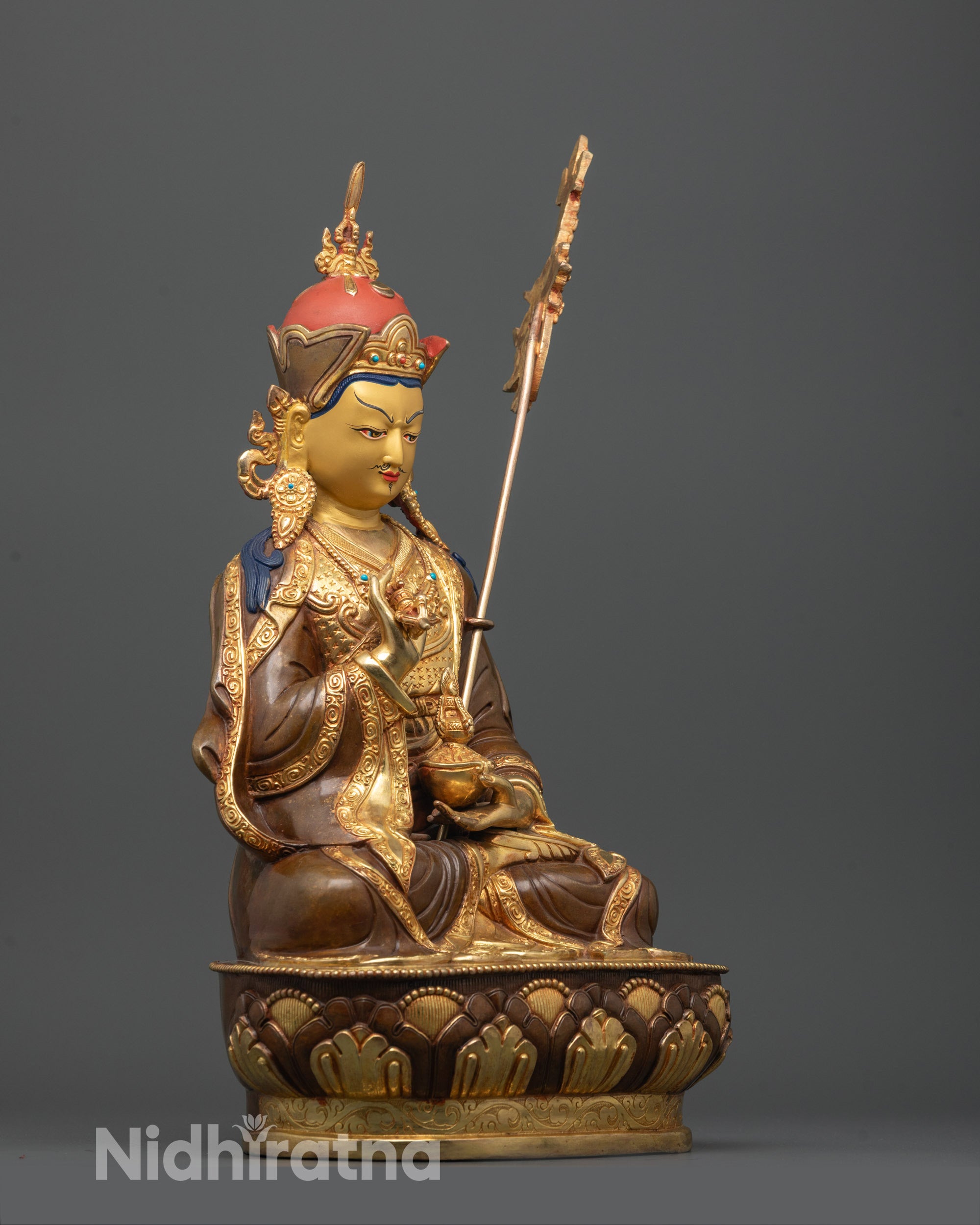 side view of handcrafted tsokye dorje statue with tripitaka robe and carved patterns
