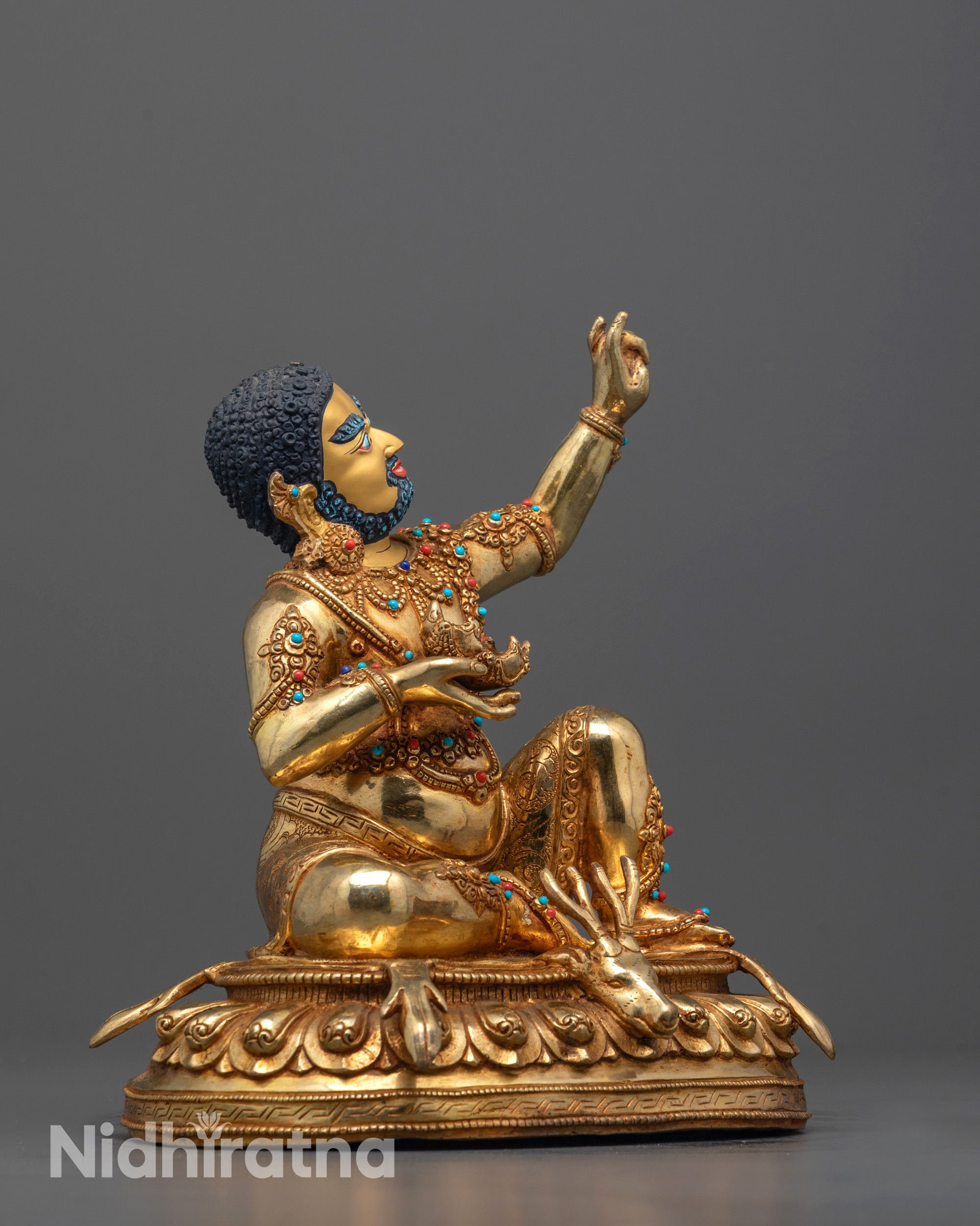 side view of handcrafted virupa statue showing sacred jewelry and semi-precious stones

