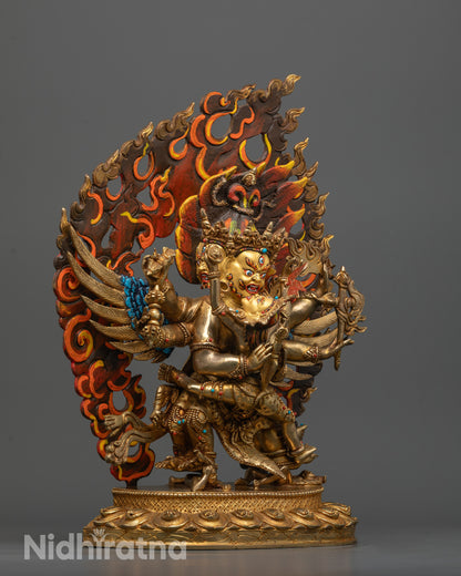 side view of vajrakilaya consort statue with three faces, six arms, and blazing halo