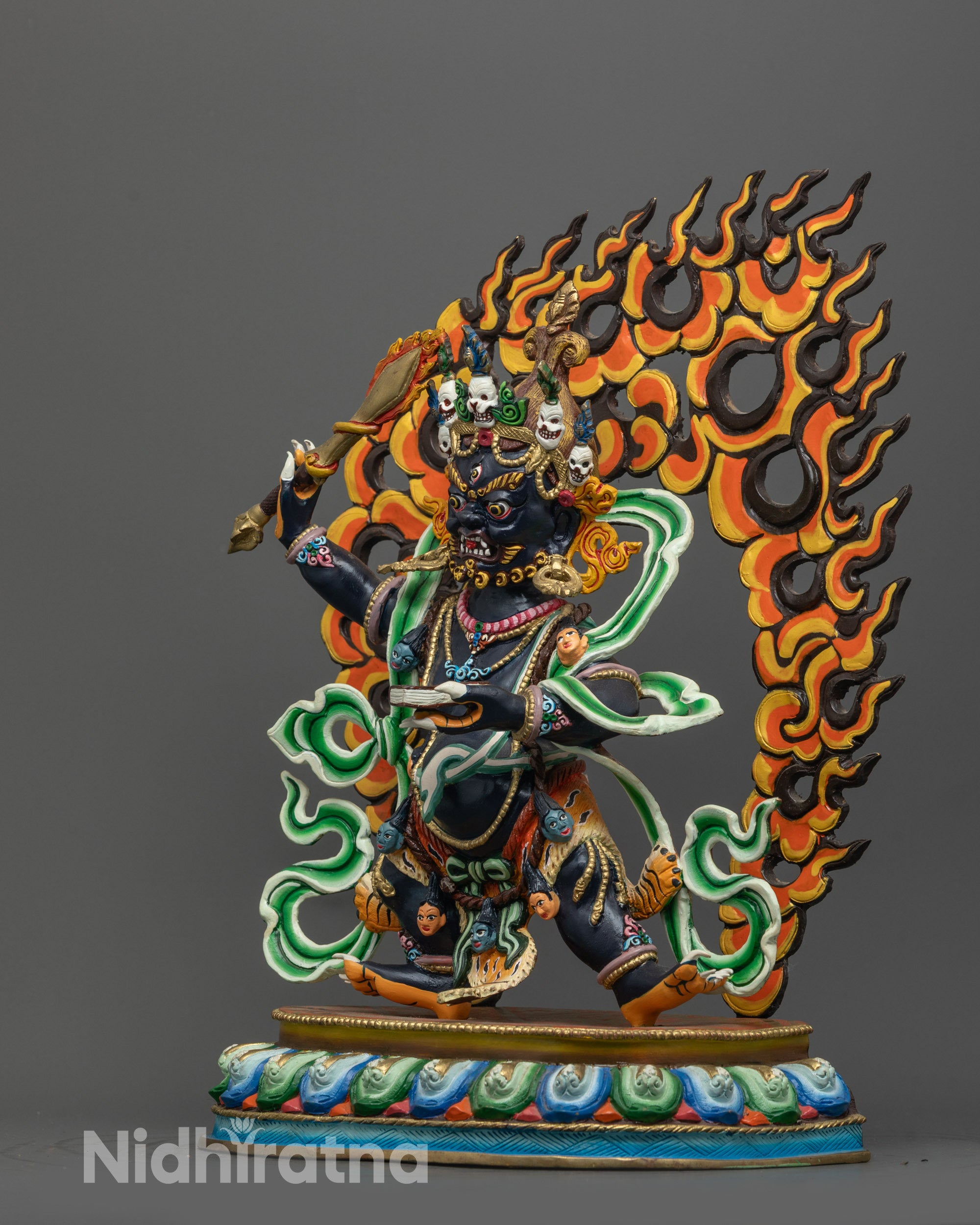 side view of wrathful manjushri copper statue holding sword and prajnaparamita sutra