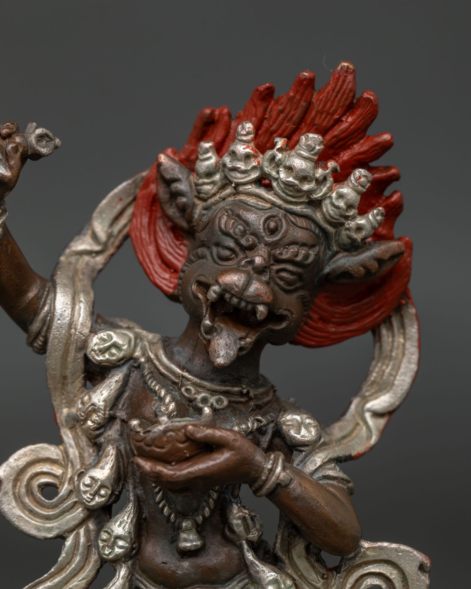 Simha Mukha statue holding kartika knife kapala and khatvanga staff.
