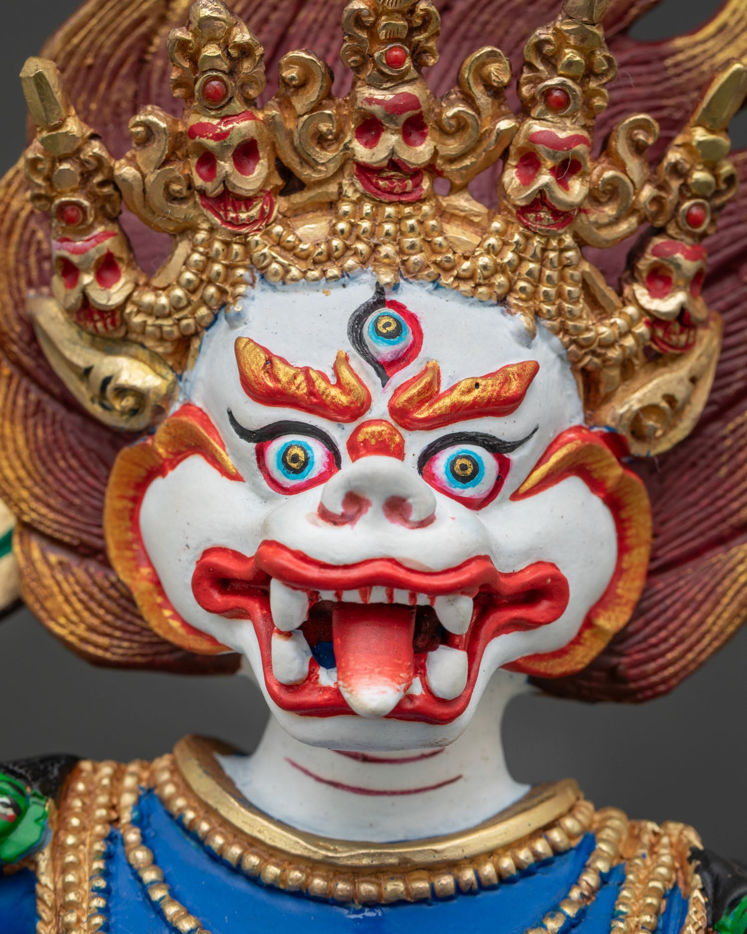 Simhamukha Statue Cambodia detailed face close up, fierce lion faced dakini with gold gilding