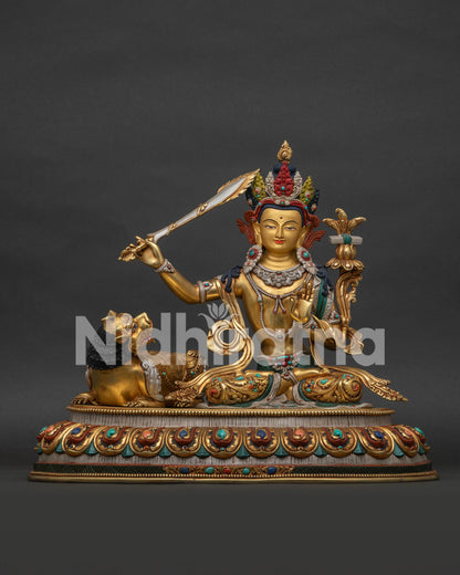 Simhanada Manjushri statue front view - gold gilded wisdom Bodhisattva with snow lion