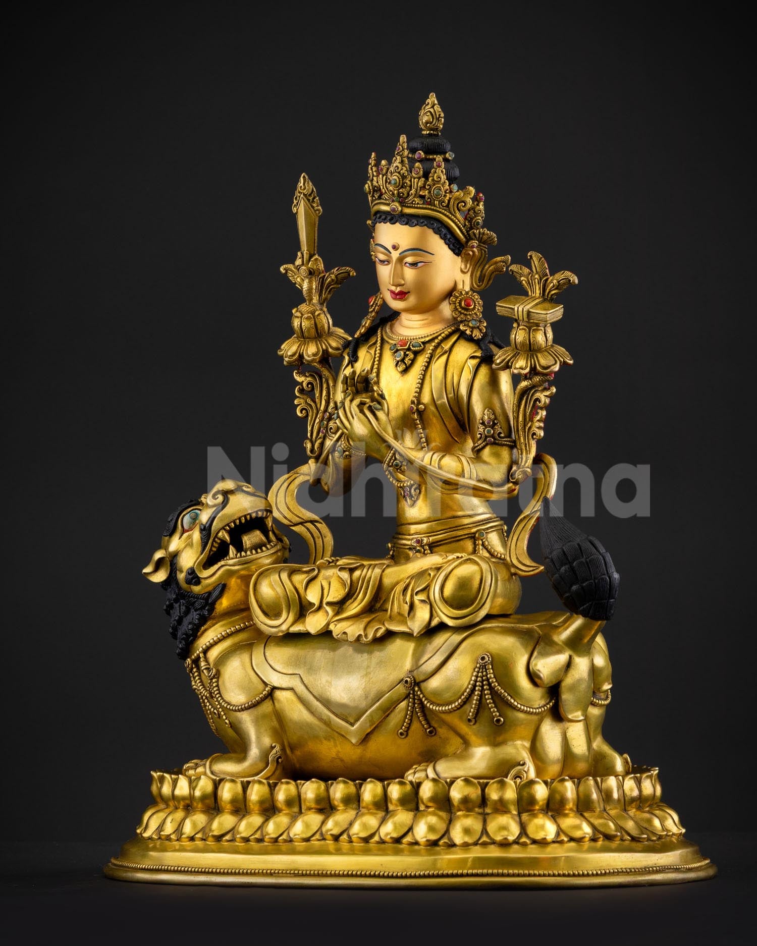 Simhanada Manjushri statue holding flaming sword of wisdom symbolizing removal of ignorance with ornate jewelry and sacred Himalayan Buddhist iconography in copper sculpture