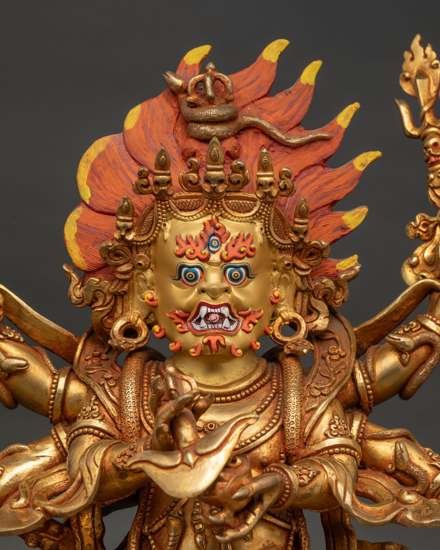 Six-Armed Mahakala Buddhist statue with fierce third eye bared fangs and gold-painted face