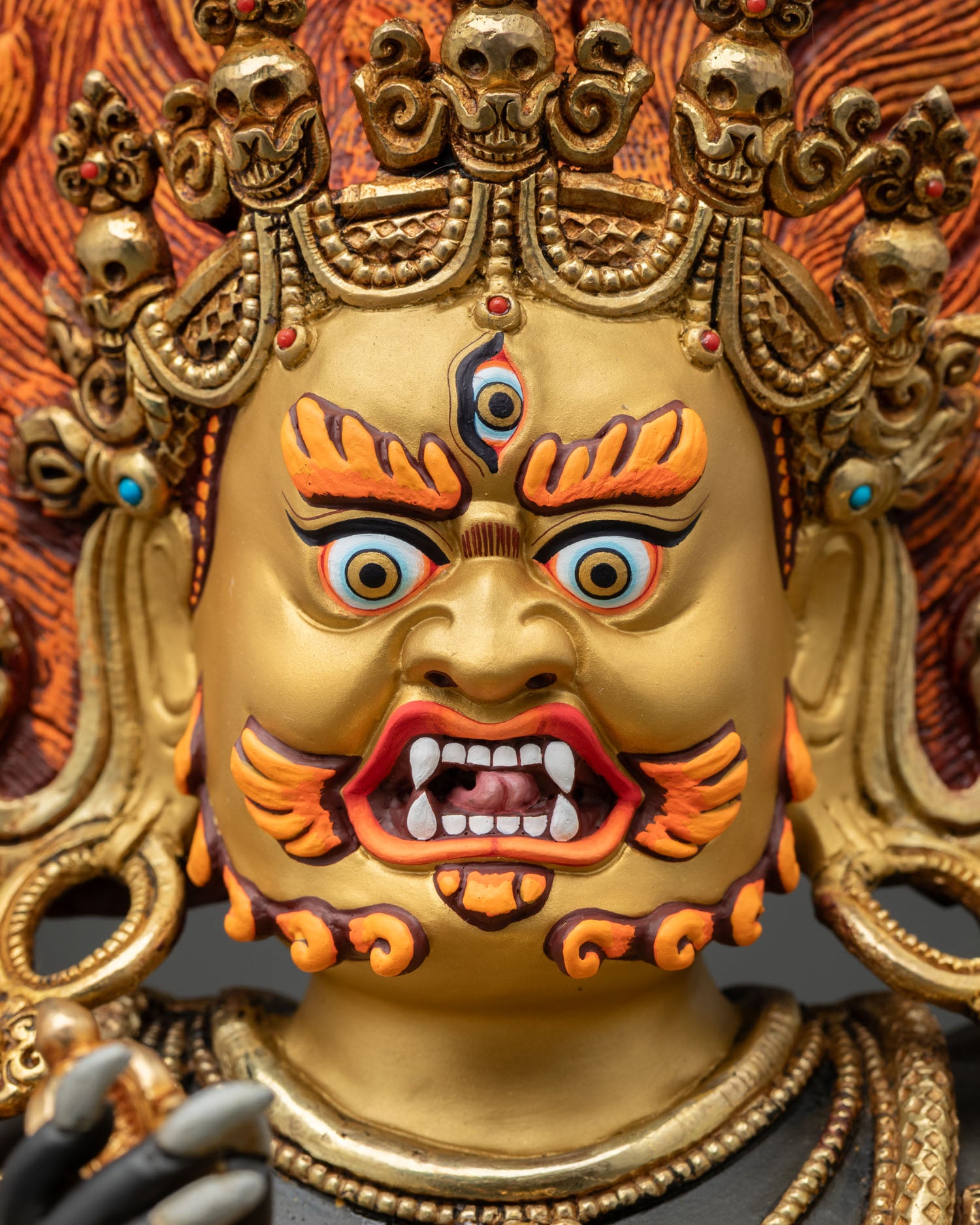 Six Armed Mahakala Face Close Up with Gold Painted Expression and Skull Crown