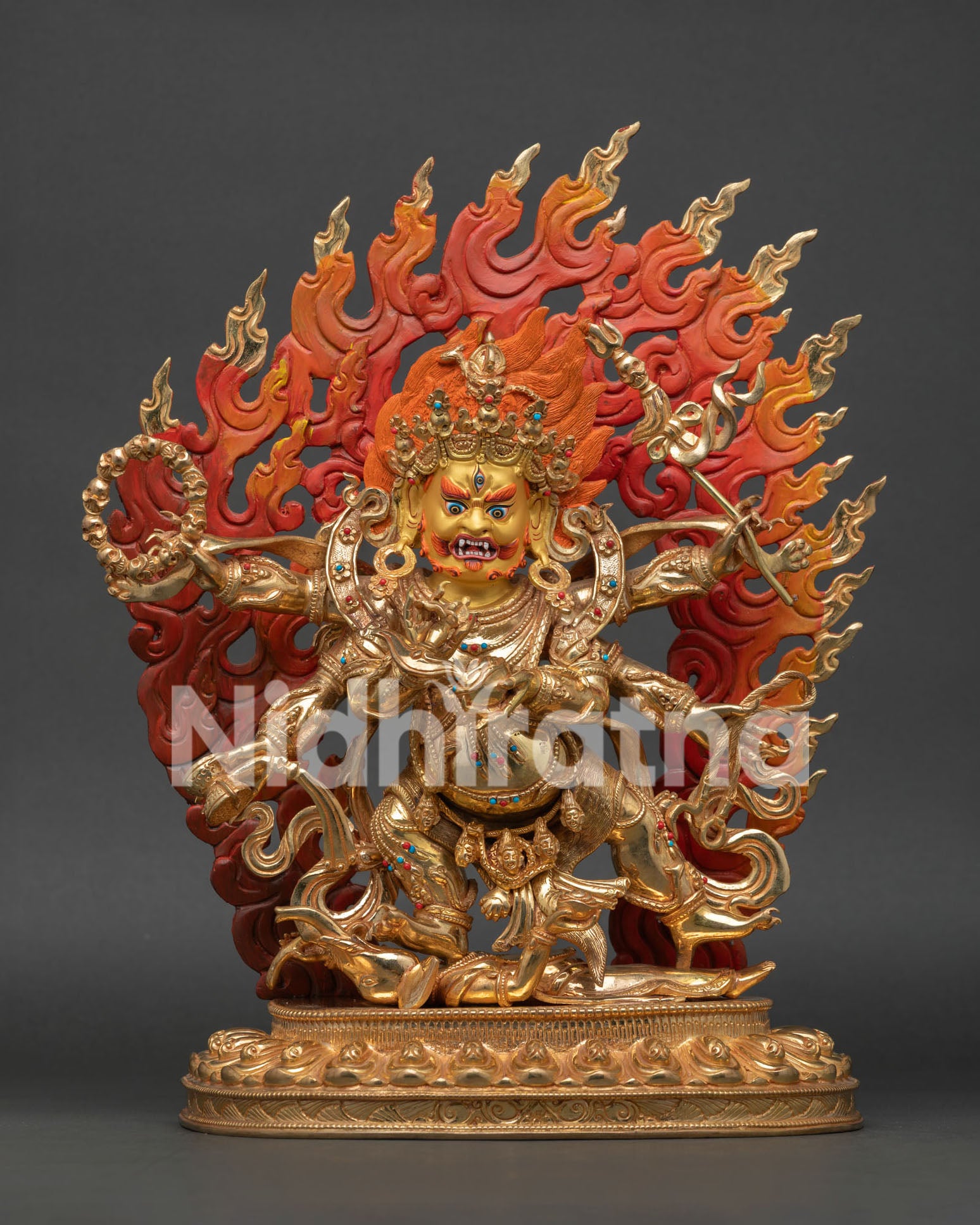 Six Armed Mahakala sits on a lotus pedestal with 24K gold gilding and turquoise coral stone accents