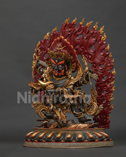 Six-armed Mahakala statue left side, highlighting the skull crown, flowing robes, and a blazing halo of wisdom fire.
