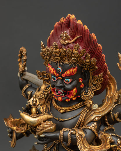 Six-armed Mahakala statue side close-up of the face, emphasizing the third eye, skull crown, and intense wrathful expression.