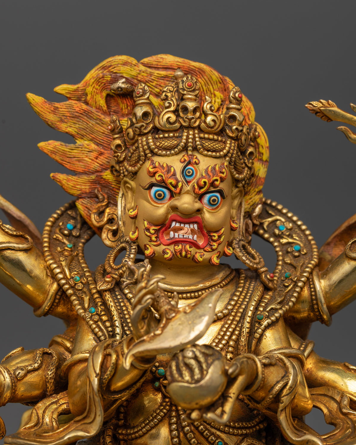 Six-Armed Mahakala statue with 24K gold-painted face third eye and bared fangs.