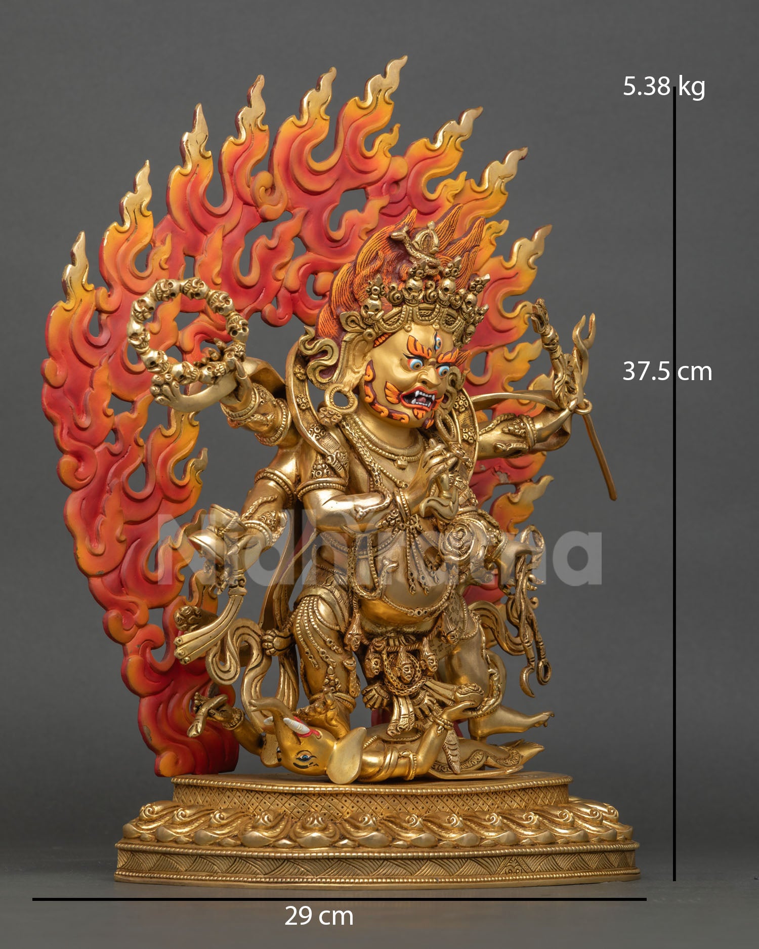 Six-Armed Mahakala with six arms holding sacred implements, standing on a subdued figure over a lotus base