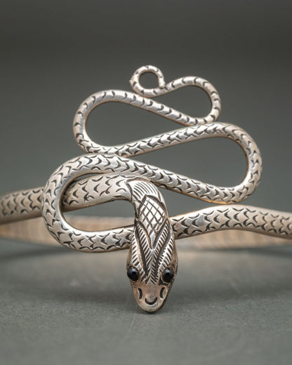 Snake cuff bracelet with intricate engraved scales and fluid coiling curves