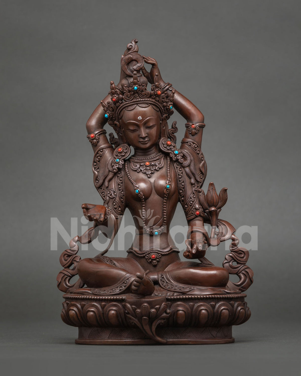 Sokavinodani Tara statue dispelling sorrow, hands raised above crown, oxidized copper