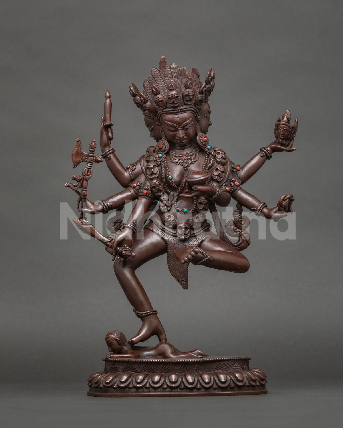 Standing Bhrkuti Tara statue, wrathful six-armed form with skull garland, oxidized copper