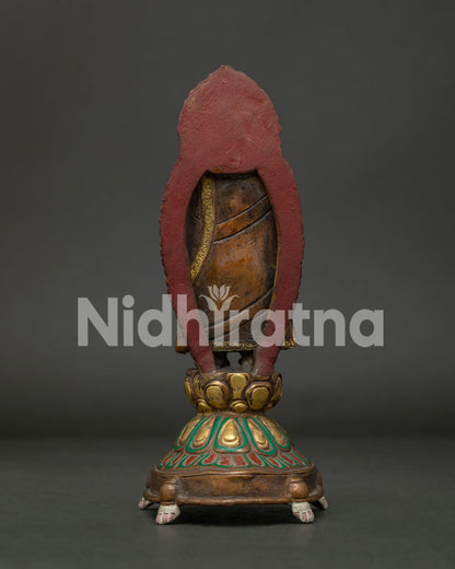 Standing Buddha statue back view handcrafted copper Buddhist sculpture from Patan Nepal.