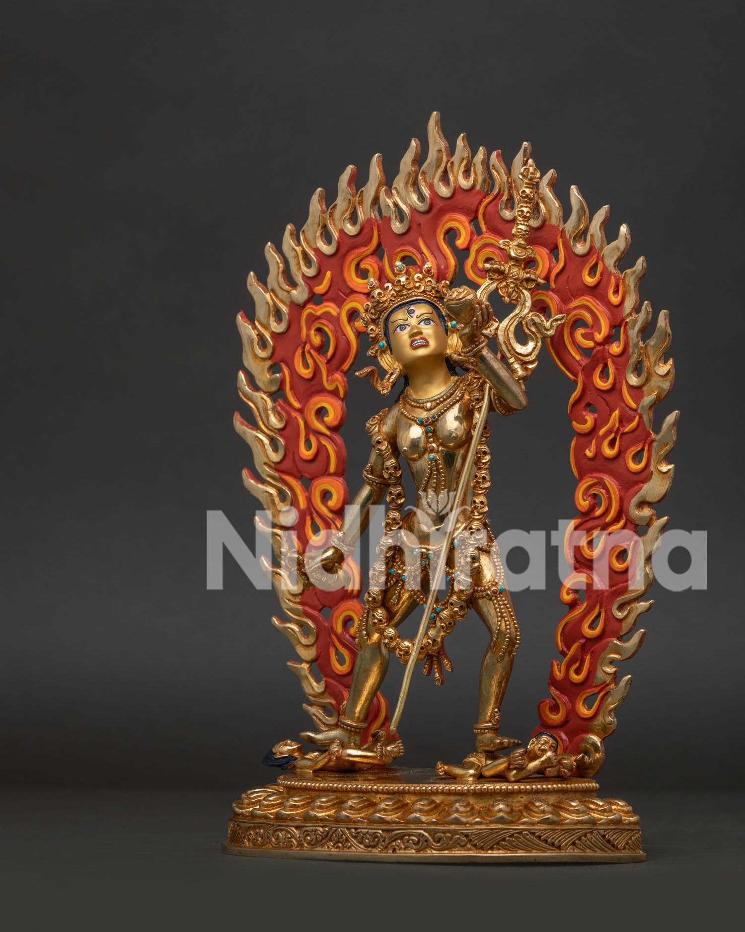 Standing Vajrayogini Statue on Lotus Pedestal Above Wrathful Human Figures.