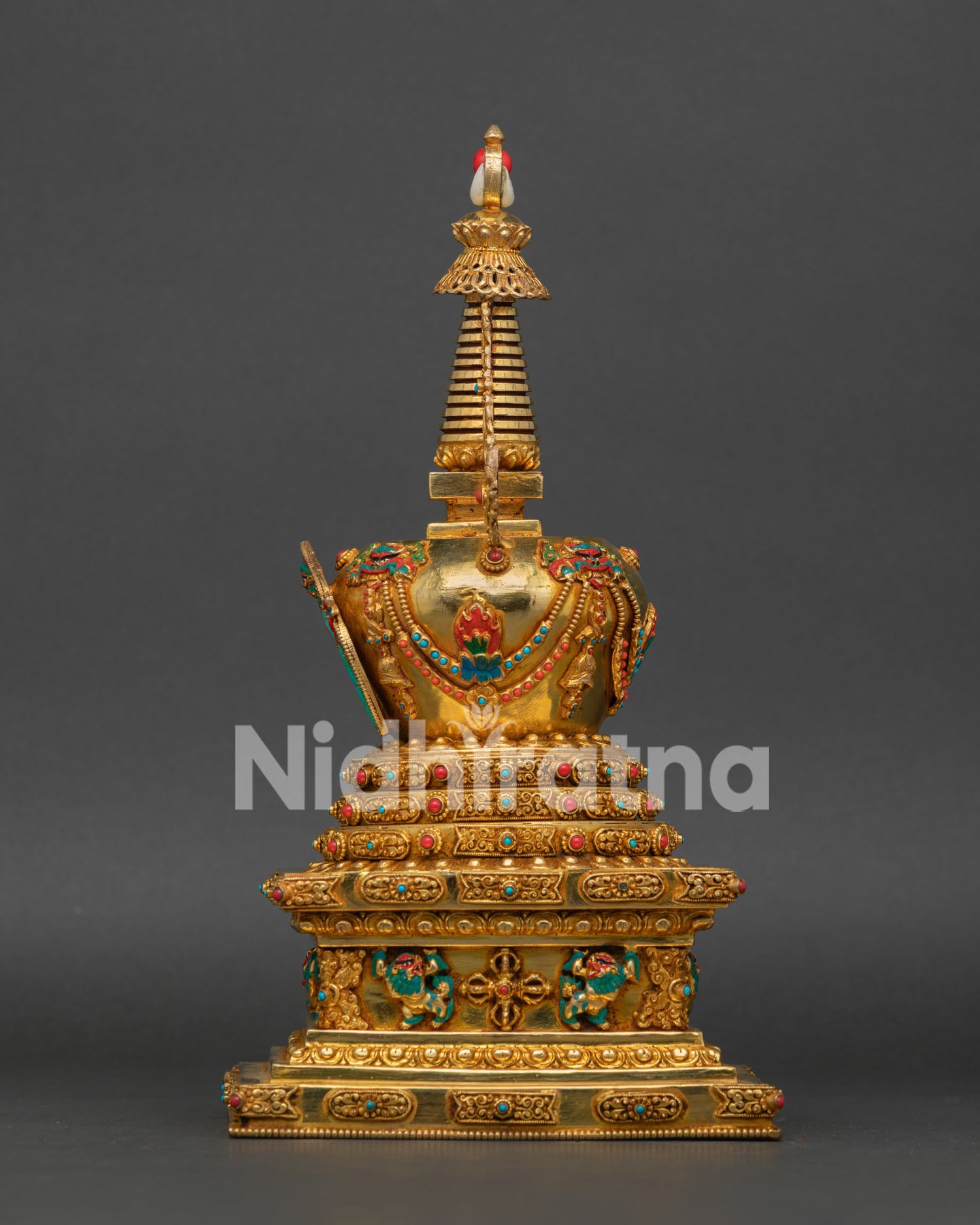 Stupa Adorned with Semi-Precious Stones and Intricate Engravings
