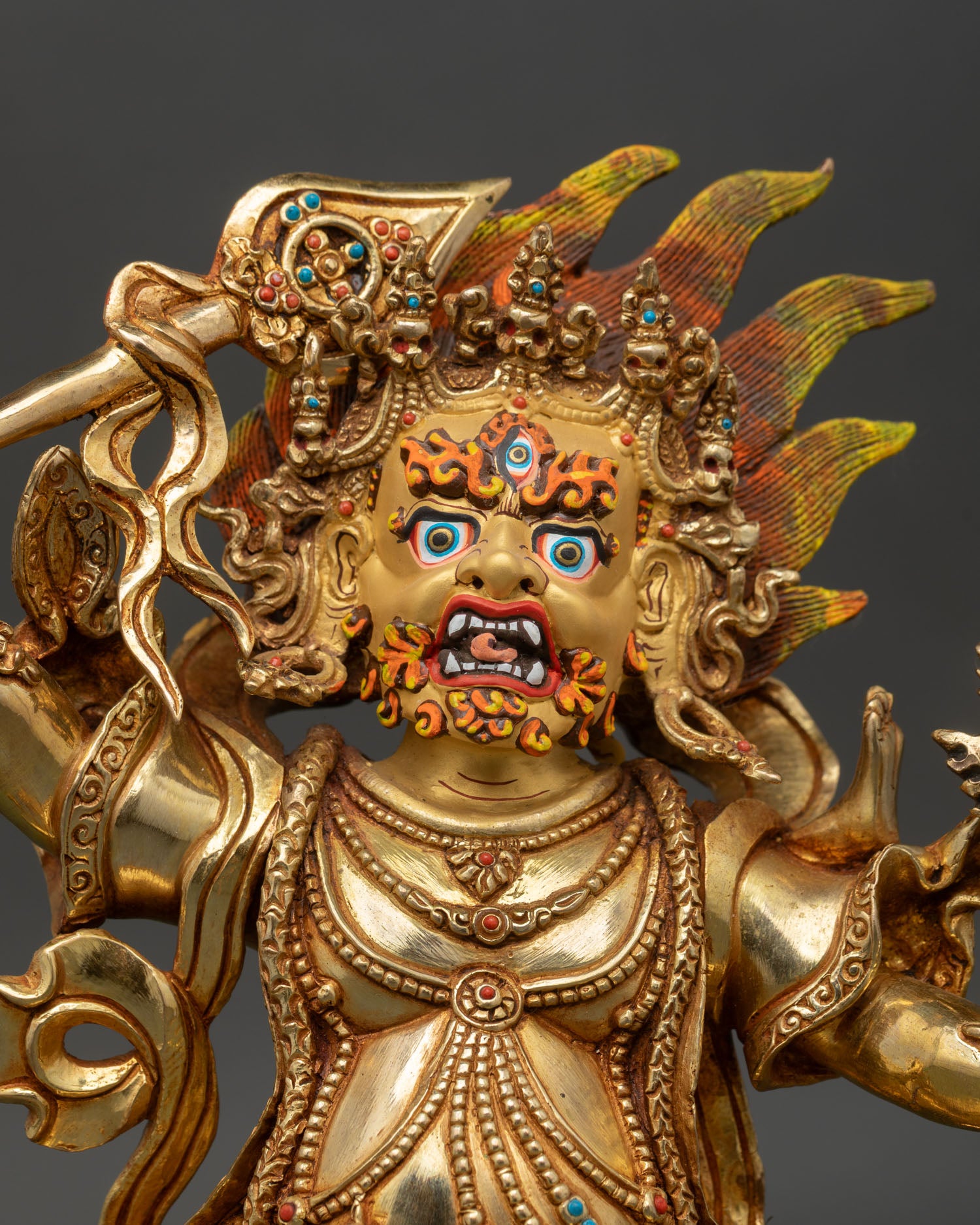Takla Mebar statue close up gold painted face semi precious stones sacred Tibetan deity detail spiritual protection art