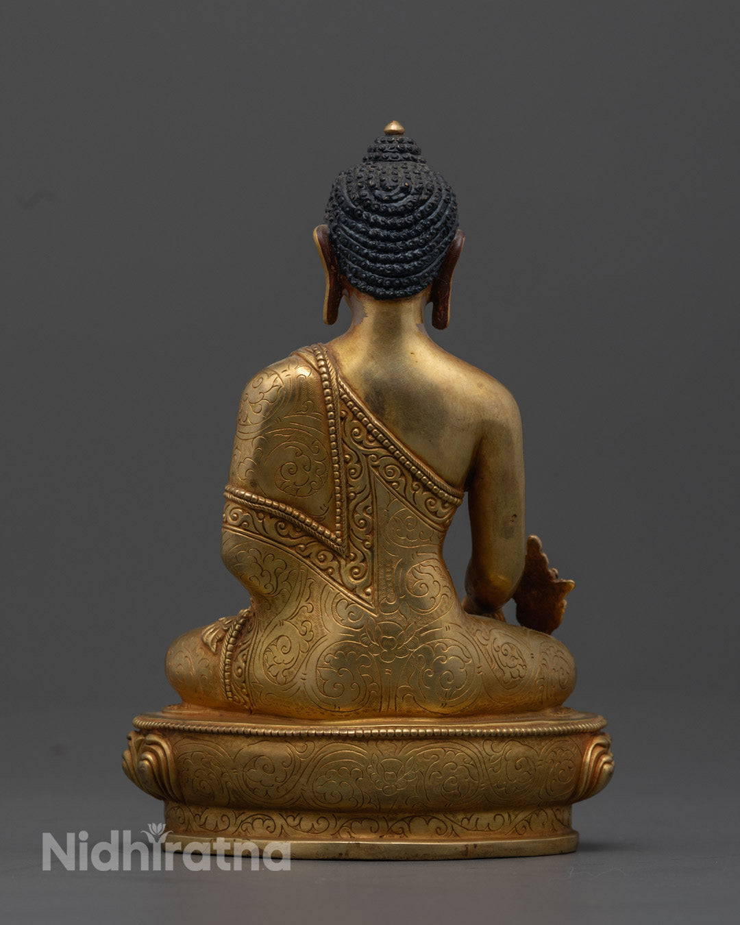 the 24K Gold-Gilded Medicine Buddha Statue displaying the intricate lotus throne and vibrant acrylic color details, emphasizing the statue's spiritual and healing symbolism.