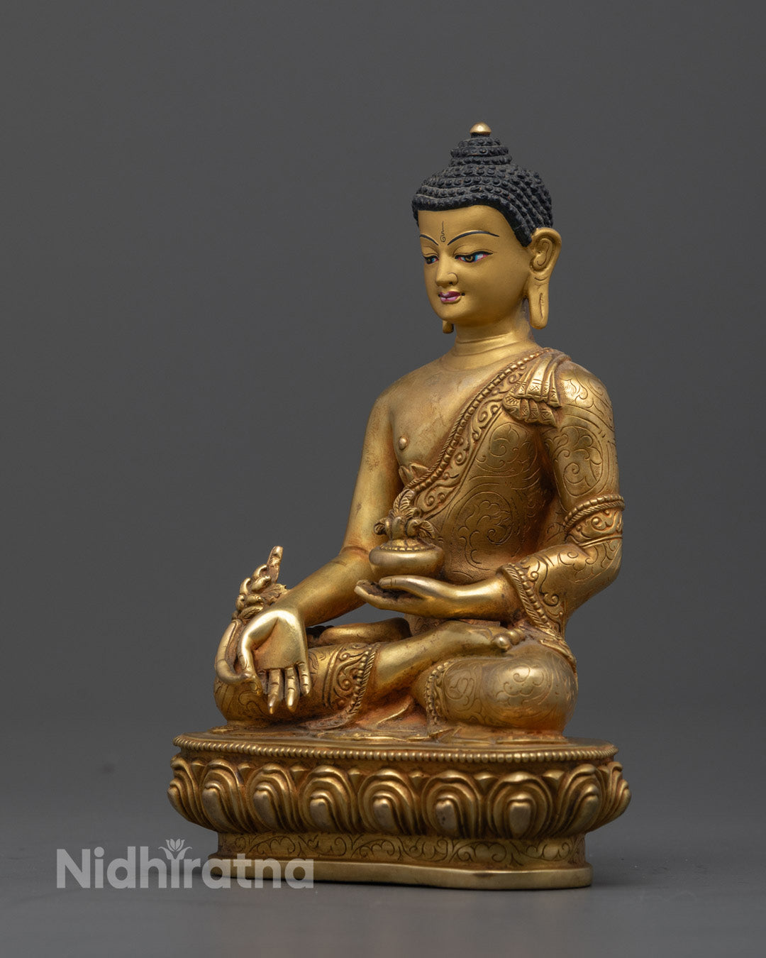 the 24K Gold-Gilded Medicine Buddha Statue's serene face, showcasing the detailed facial expressions and the fine craftsmanship of the handcrafted Nepalese statue.