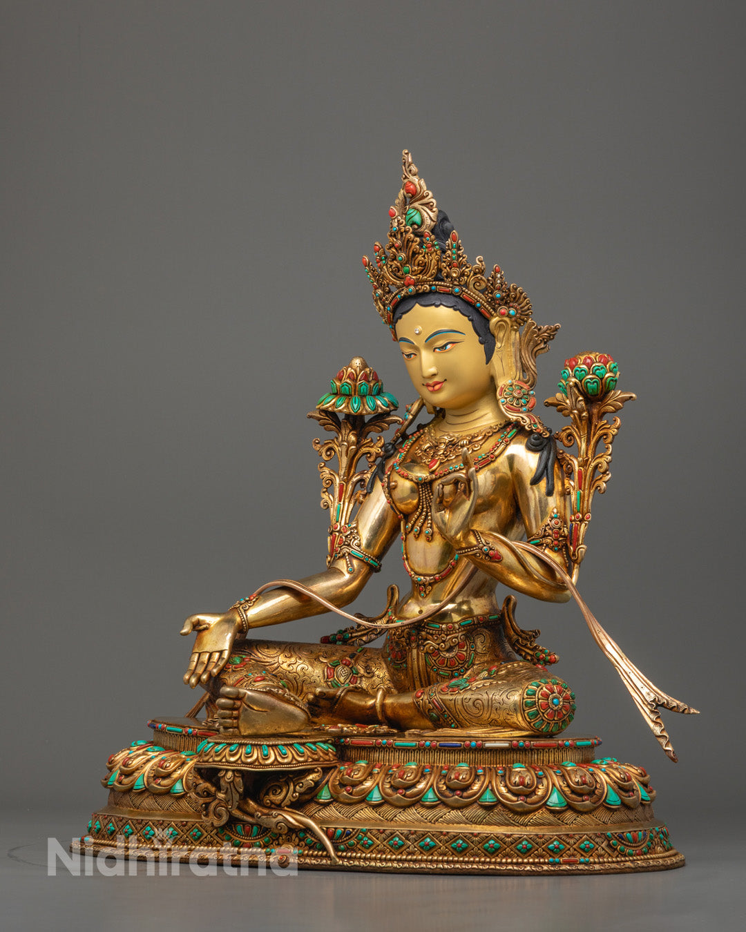 the floating robe and uptala flower adorned with semi-precious stones on handcrafted Mother Green Tara sculpture