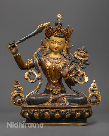 the gold-gilded face of the Oxidized Manjushri Bodhisattva Statue showcasing intricate craftsmanship by Nepalese artisans