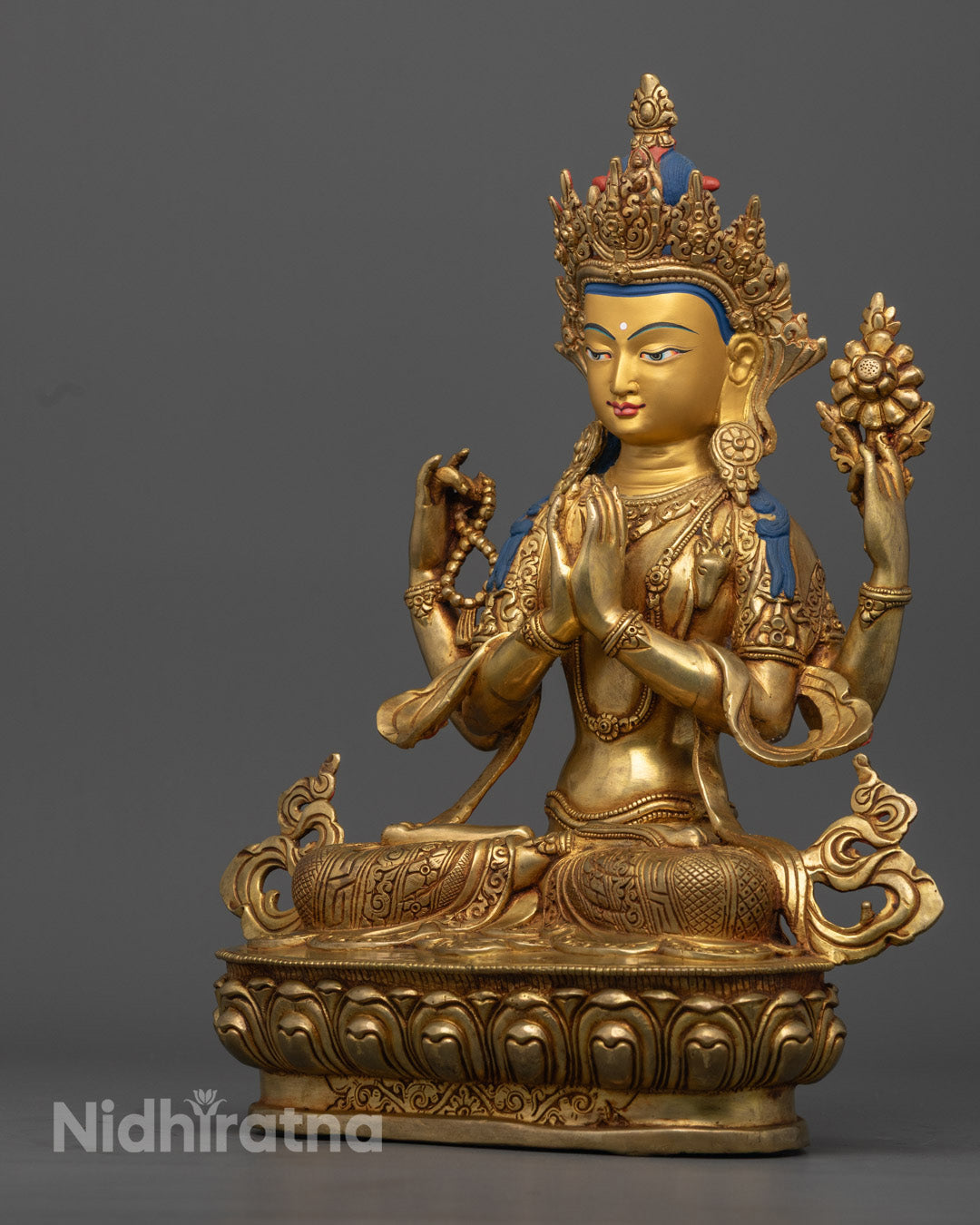  the upper left hand of Chenrezig statue holding a crystal rosary (mala), symbolizing continuous compassionate action.